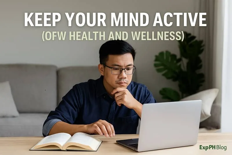 A Filipino man studying at home while using a laptop and an open book, symbolizing the importance of keeping the mind active for OFW health and wellness, with the ExpPH Blog logo in the image.
