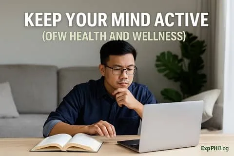 A Filipino man studying at home while using a laptop and an open book, symbolizing the importance of keeping the mind active for OFW health and wellness, with the ExpPH Blog logo in the image.