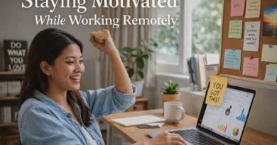 Filipino remote worker smiling at her laptop while staying motivated and productive in a home office setup