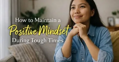A hopeful Filipino woman sitting calmly at home, representing how to maintain a positive mindset during tough times.