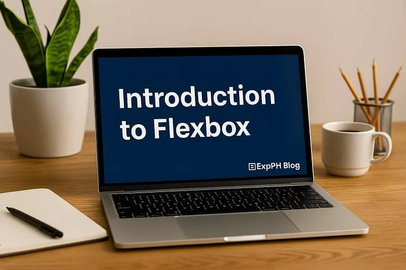 Laptop on a desk showing Introduction to Flexbox with a small ExpPH Blog logo