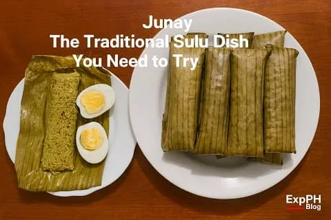 A plate of traditional Sulu Junay wrapped in banana leaves, with one unwrapped Junay served beside sliced hard boiled eggs on a white plate.