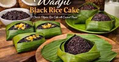 Traditional Wadjit black rice cake wrapped in banana leaves with coconut topping, a classic Filipino rice dessert from Mindanao and Sulu