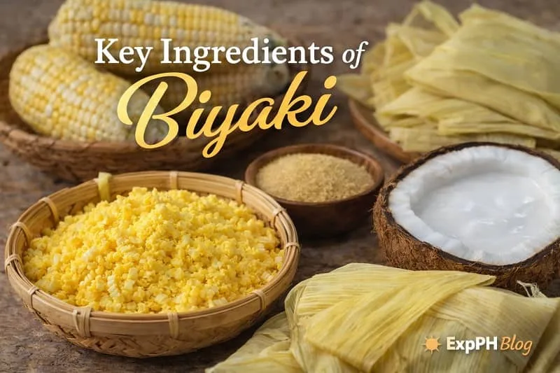 Young corn, coconut milk, sugar, and corn husks arranged on a wooden table with ExpPH Blog logo, showing the key ingredients of Biyaki