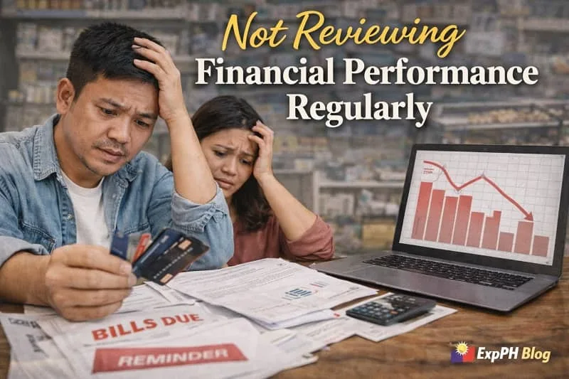 Filipino small business owners looking stressed while reviewing unread financial reports and charts, showing the impact of not reviewing financial performance regularly with ExpPH Blog logo visible